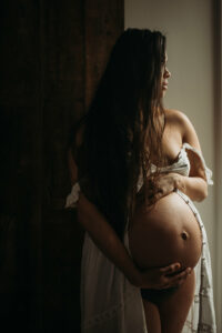 Photo of pregnant woman cradling her belly